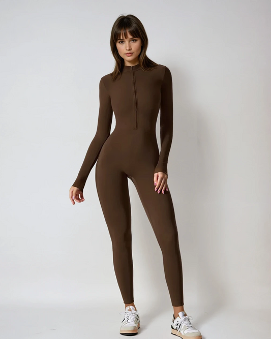 Woman wearing a brown bodysuit against a white background