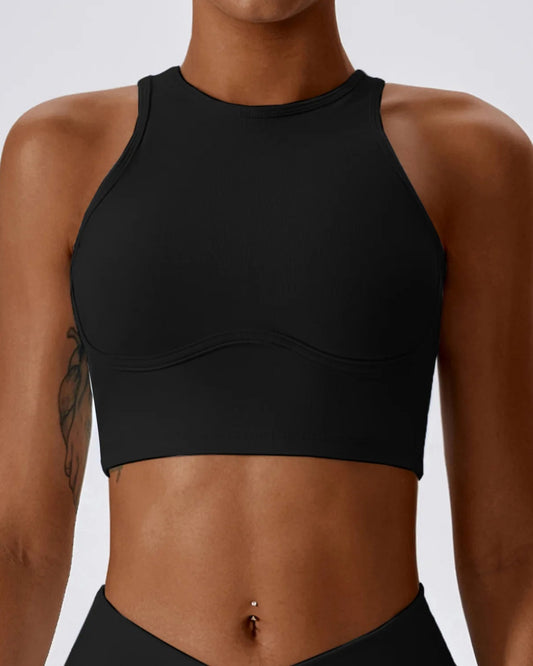 A person wearing a light blue ribbed form bra with a scoop neckline and sleeveless design.